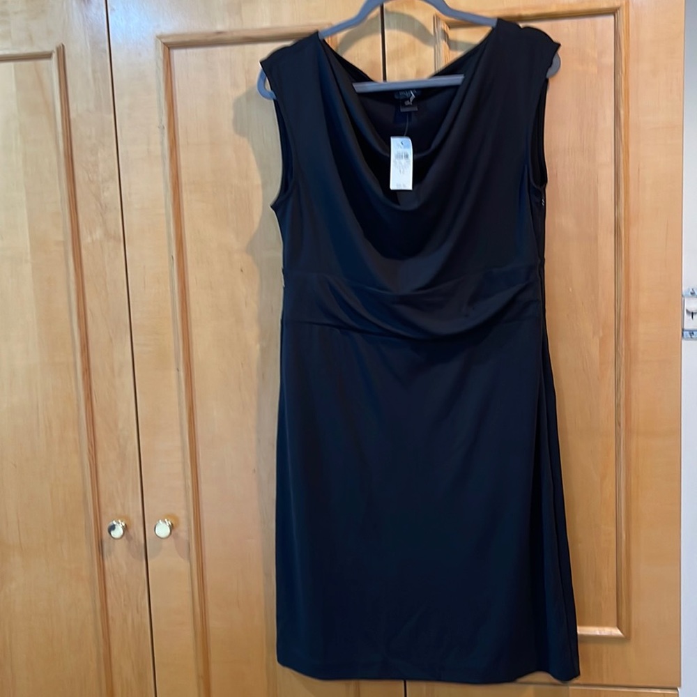 A new Size 12 black Ann Taylor dress with side zipper and touching at the waist.